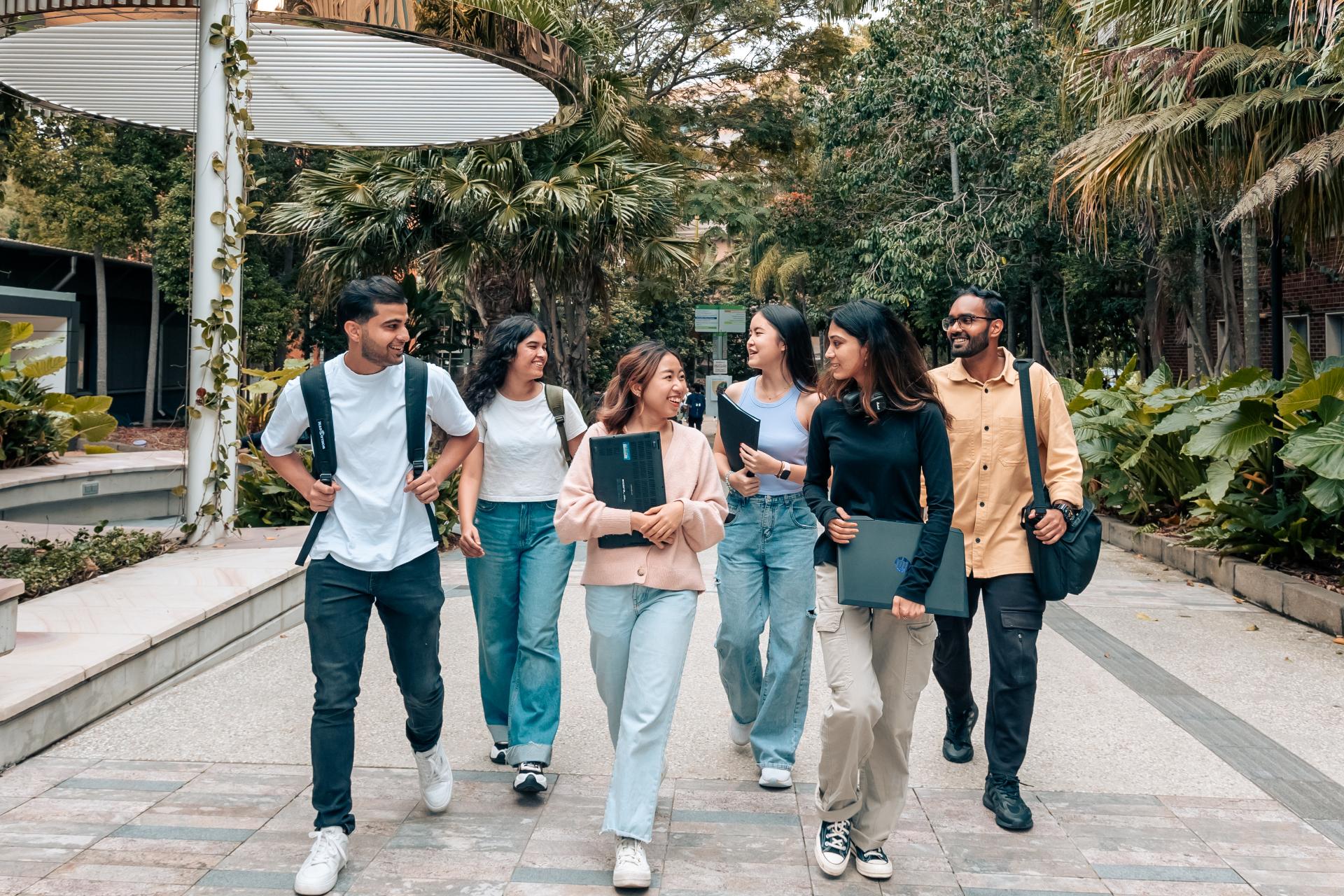 A group of students walking through the University of Queensland campus in Brisbane.